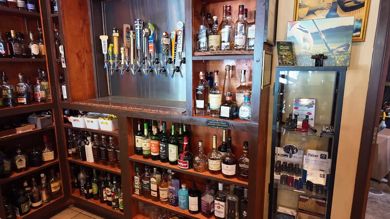 The tap handles and shelves of liquor bottles behind the bar.